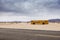 29 Palms, California/USA-03/21/2016: School Bus in the desert, 29 palms, Boy is walking towards the horizon.