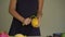 2x times Slowmotion shot of a young woman peeling the mango and lots of tropical fruits lay on a table