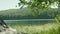 3 in 1. Set of footages with lake in the forest. In the foreground there are branches of trees. Tree branch in the