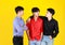 3 adults asian handsome men are friends and 1 of them feeling sad but his 2 friends standing to encouragement. Shooting in studio