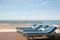 3 beach beds in front of oriental resort with beautiful beach, sand, clear sky in summer vacation