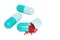 3 blue and white pills capsule one filled full of mini red hearts on object white background. Pharmacy and dietary supplements.