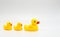 3 bright yellow rubber ducks with red beaks