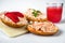 3 canapÃ©s with salmon spread with fresh cheese on board, glass of juice