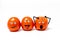 3 cheerful anthropomorphic tomatoes with expressive faces on a white background