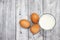3 glasses of milk and eggs, on a gray wood background, food-beverage background