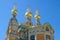 3 golden towers with golden crosses of russian chapel at Mathildenhoehe Darmstadt against blue sky