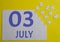3 july calendar date on a white puzzle with separate details. Puzzle on a yellow background with a blue inscription