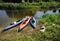 3 kayaks on the bank of a small river in summer