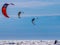 3 kite surfers on the sea