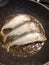 3 Mackerel fishes fried in a pan