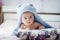 3 months baby boy weared in funny hat lying down on a blanket. A portrait of a cute blond baby