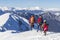 3 mountain climbers walk on snow in the mountains