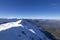 3 mountain climbers walk on snow in mountains