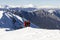 3 mountain climbers walk on snow in  mountains