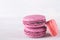 3 multicolored macaron cookies, on grey background