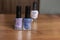 3 nail polishes stand on a table