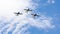 3 performance jets, flying in tandem, on a blue sky with white clouds