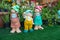 3 Porcelain garden dolls in the middle of plantings from the Flower Show in Doha, Qatar 2