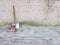 3 shovels of different colors and shapes stand against a brick wall.