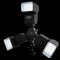 3 Speedlight flashes guns on tripod holder isolated on black