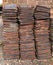 3 tall stacks of house roof tiles or shingles.