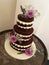 3 tier chocolate naked cake with fresh flowers