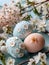 3 vintage decorated eggs surrounded by apple twigs