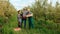 3 young people farmers men boxes hands woman a tablet examine apple fruits