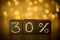 30% discount sign chalk written on black cubes on blurred bokeh background