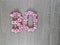 30, thirty - vintage number of pink roses on the background of dark wood