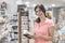 30 years old woman looking agenda in library and crafts store, smiling