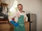 30s to 40s happy and attractive man wearing kitchen apron posing cool enjoying washing dishes and doing housework smiling