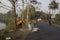 30th December, 2021, Baraipur, West Bengal, India: Two workers installing electric pole beside road and connecting with aluminum