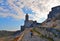 31.03.2019. San Pietro church, Lord Byron Natural park with young woman in Portovenere village on stone cliff rock and blue sky, v