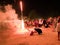 31 december 2016 sihanoukville beach cambodia, adult asian man kneeling on beach under fireworks explosion