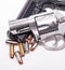 A 357 magnum revolver on top of a 40 caliber pistol with eight 40 caliber hollow point bullets