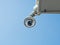 360 Degree fish eye dome CCTV installed under the building balcony against blue sky