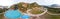 360-degree panorama from the air to a tourist recreation center in the Altai mountains with hotel buildings and pools on a warm