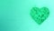 3d animation: Abstract looped animated background: Rotating luminous emerald heart formed pieces and cubes of green spinning