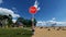 3D animation girl with colorful balloons in front of a stop sign, climate change concept