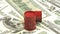 3d animation: Red barrels of oil lie on the background of dollar money. Petroleum business, black gold, gasoline production. Purch