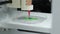 3D bioprinter printing a biomaterial onto an electrode