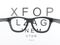 3d Black reading glasses focus on eye chart