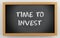 3d chalkboard with time to invest text