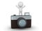 3D Character Standing with Arms Up on top of large photo camera