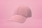 3d close-up rendering of pink baseball cap floating on pink background.