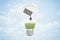 3d closeup rendering of electric bulb with black oil barrel tipped and spilling oil drop on green grass, all inside the