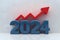 3D depiction of 2024 in bold blue numbers with upward red arrow symbolizing growth