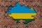 3D Flag of Rwanda behind the stone wall